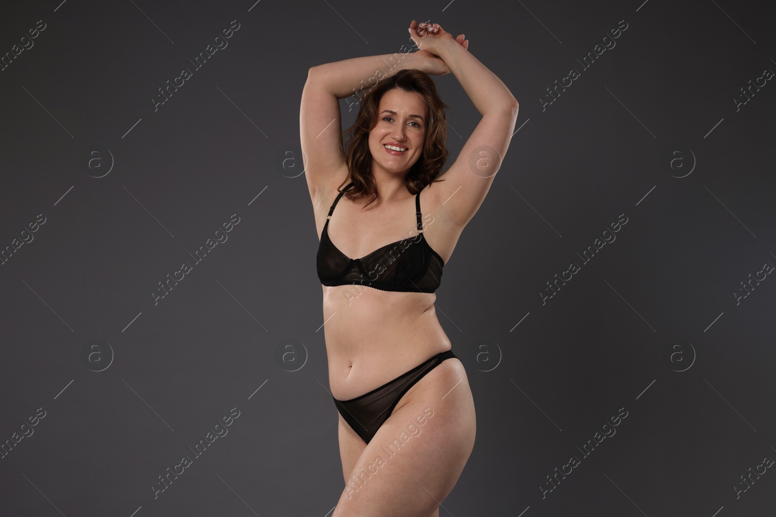 Photo of Beautiful woman in underwear on dark grey background. Cellulite problem