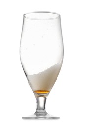 Photo of Almost empty glass of beer isolated on white