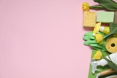 Photo of Spring cleaning. Detergents, supplies and tulips on pink background, flat lay. Space for text