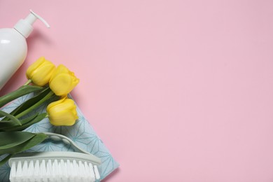 Photo of Spring cleaning. Detergent, supplies and tulips on pink background, flat lay. Space for text