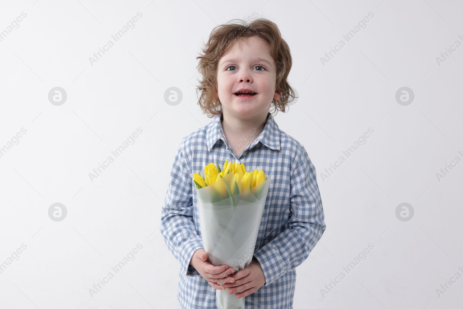 Photo of Cute little boy with bouquet of tulips on white background