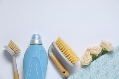 Photo of Spring cleaning. Detergent, supplies and flowers on white background, flat lay. Space for text