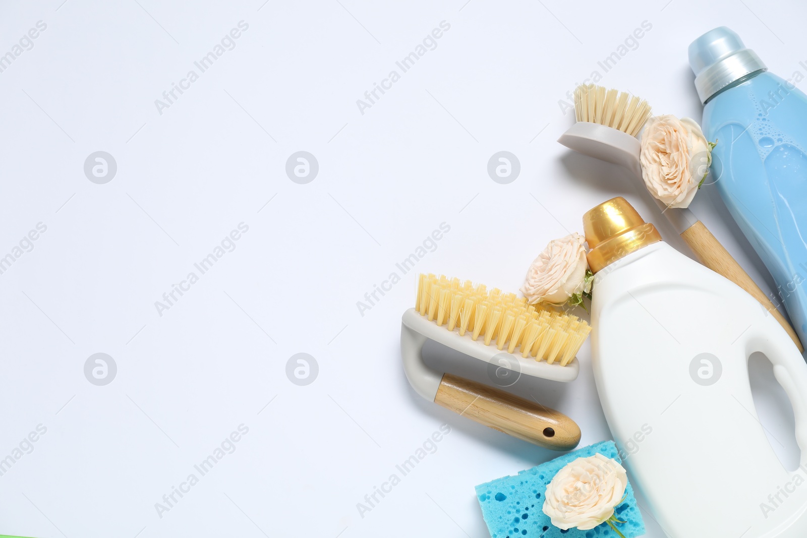 Photo of Spring cleaning. Detergents, supplies and flowers on white background, flat lay. Space for text