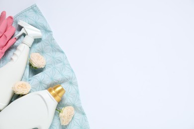 Photo of Spring cleaning. Detergents, supplies and flowers on white background, flat lay. Space for text