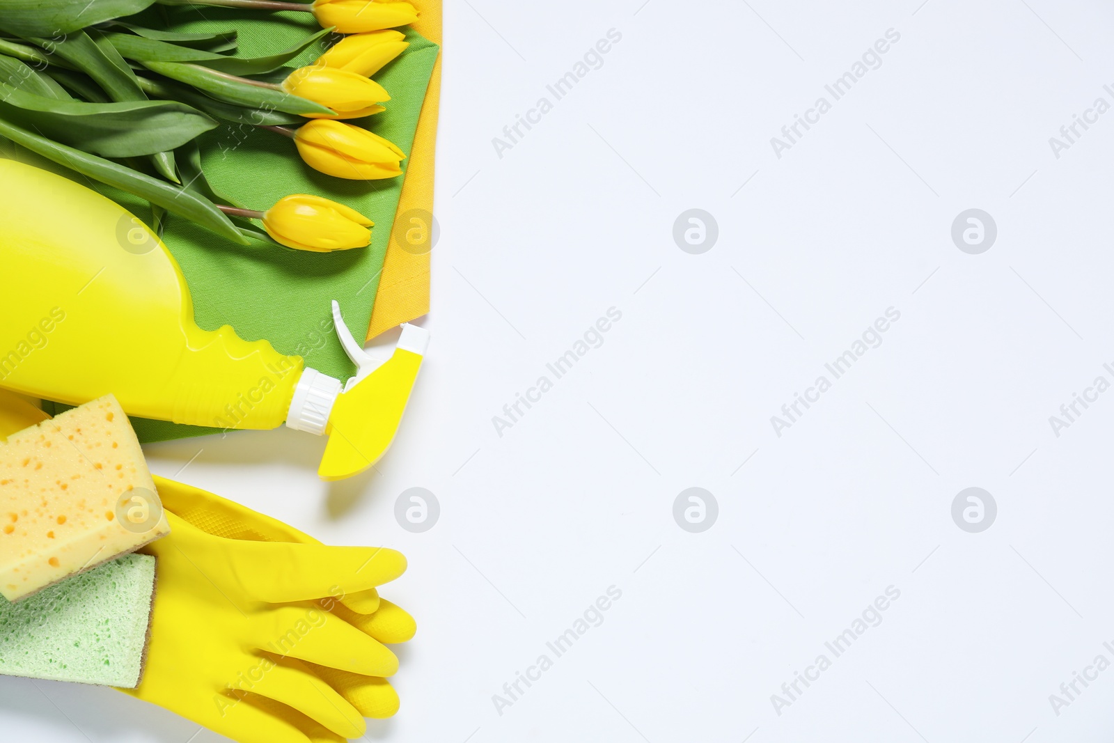 Photo of Spring cleaning. Detergent, supplies and tulips on white background, flat lay. Space for text