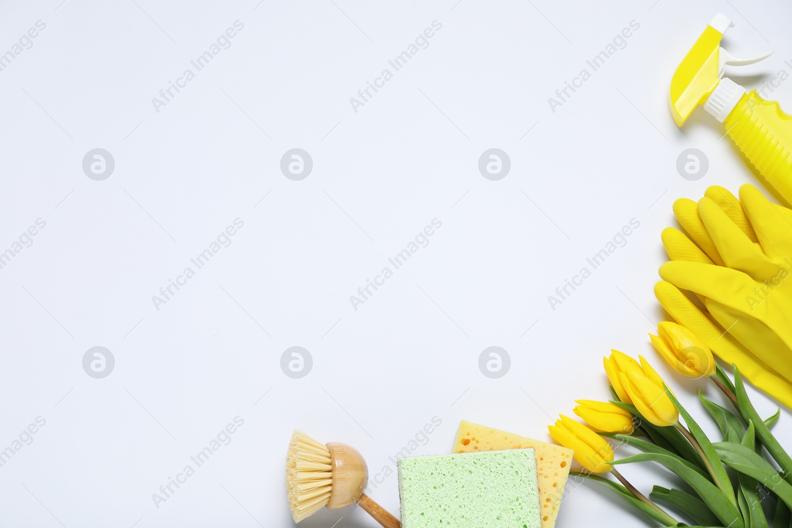 Photo of Spring cleaning. Detergent, supplies and tulips on white background, flat lay. Space for text