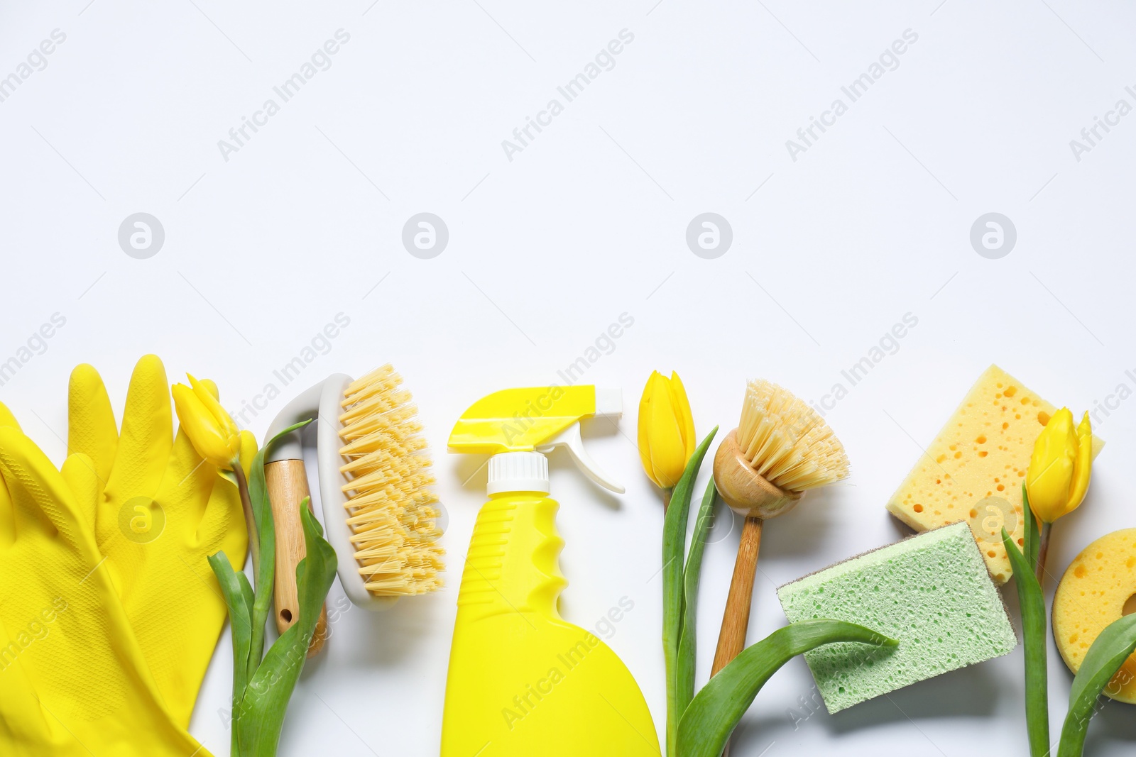 Photo of Spring cleaning. Detergent, supplies and tulips on white background, flat lay. Space for text