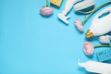 Photo of Spring cleaning. Detergents, supplies and flowers on light blue background, flat lay. Space for text