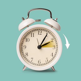 Image of Daylight saving time. White alarm clock on pale turquoise background. Highlighted area and arrow showing time change by one hour forward