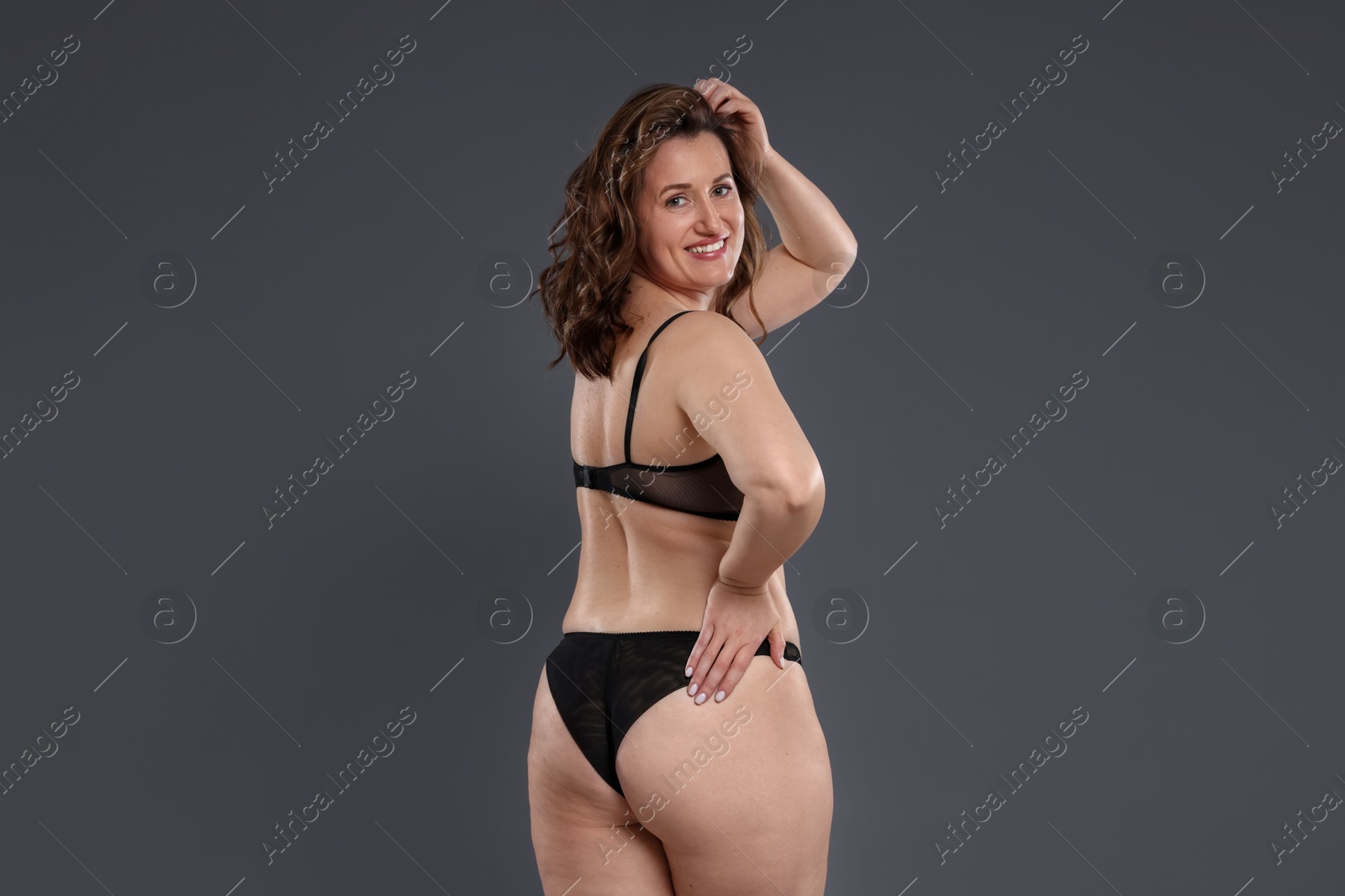 Photo of Beautiful woman in underwear on dark grey background. Cellulite problem