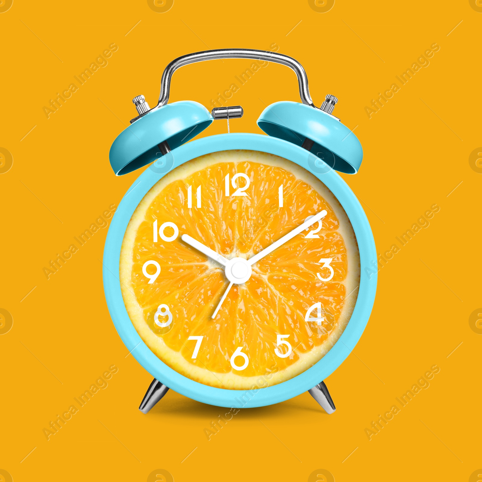 Image of Alarm clock with sliced orange instead of dial on orange background