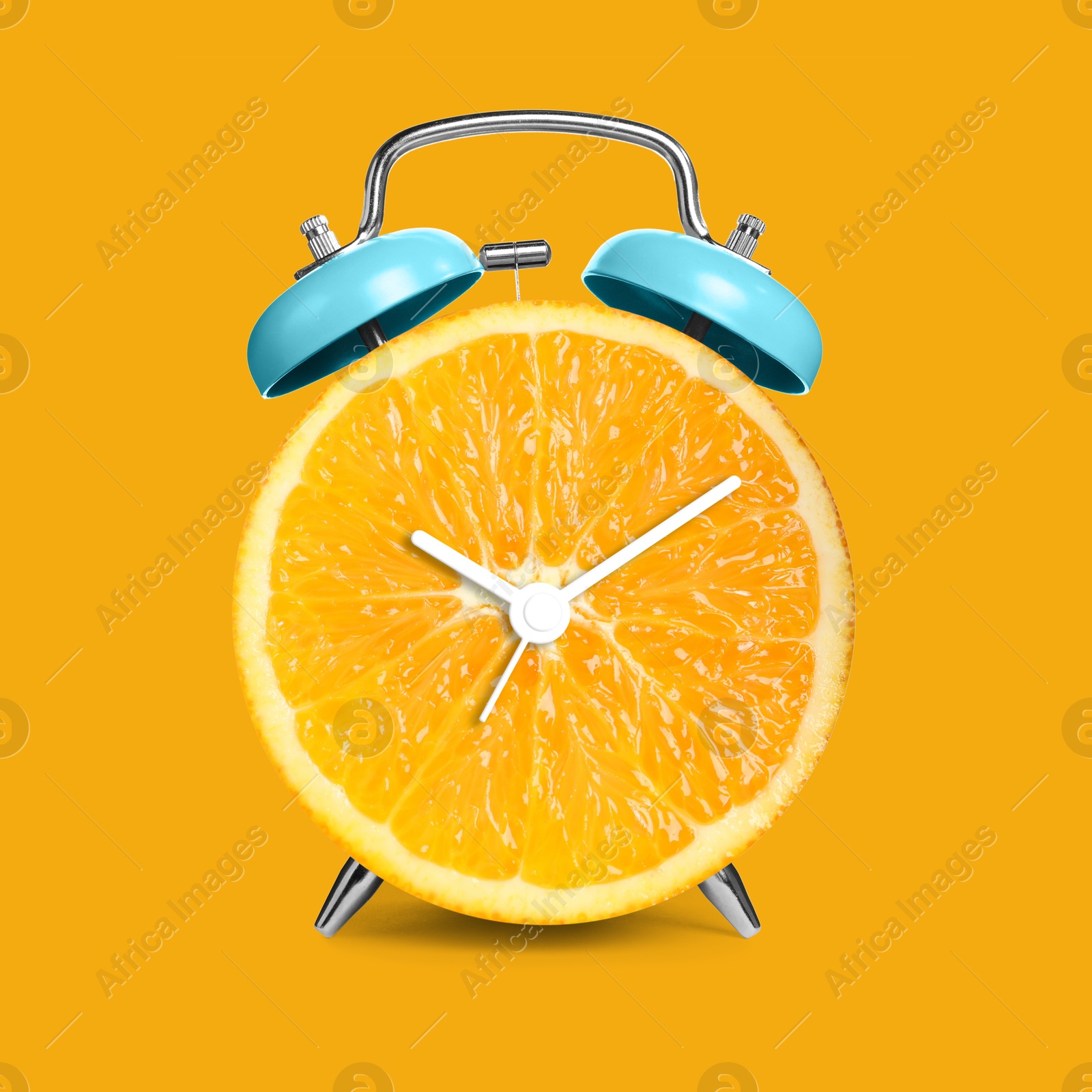 Image of Alarm clock with sliced orange instead of dial on orange background