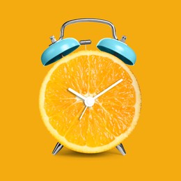 Image of Alarm clock with sliced orange instead of dial on orange background