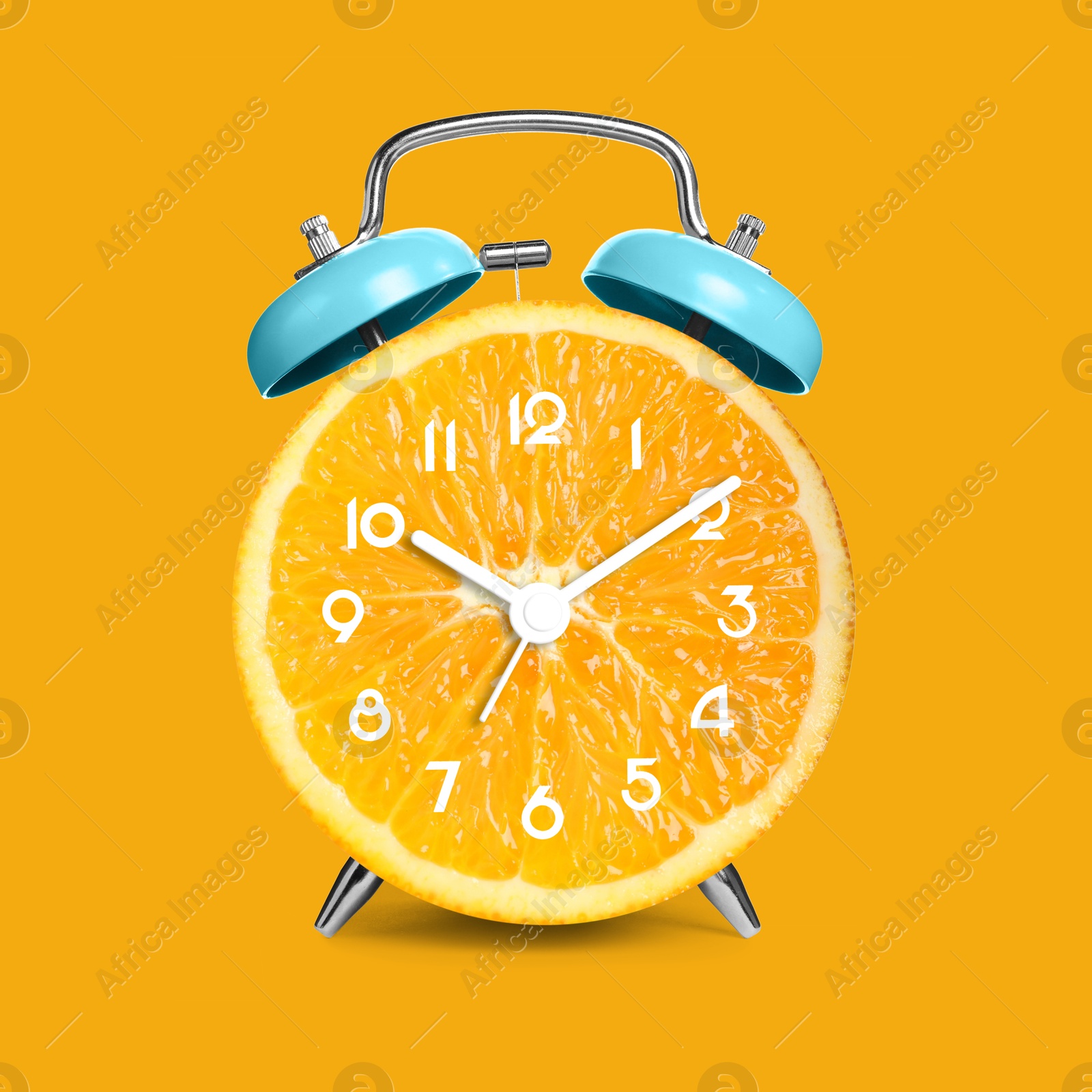 Image of Alarm clock with sliced orange instead of dial on orange background