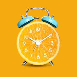 Image of Alarm clock with sliced orange instead of dial on orange background