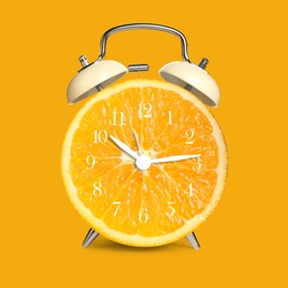 Image of Alarm clock with sliced orange instead of dial on orange background