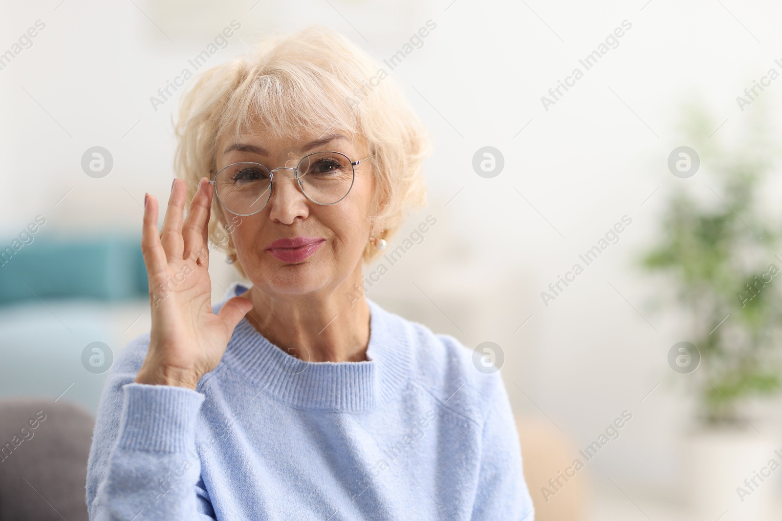 Photo of Portrait of grandmother in glasses at home. Space for text