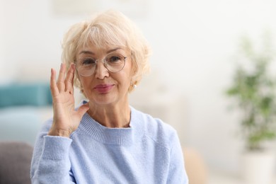 Photo of Portrait of grandmother in glasses at home. Space for text