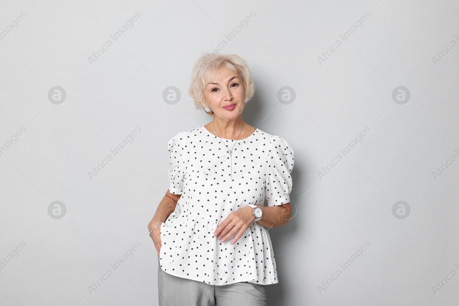 Photo of Portrait of elegant grandmother on light grey background