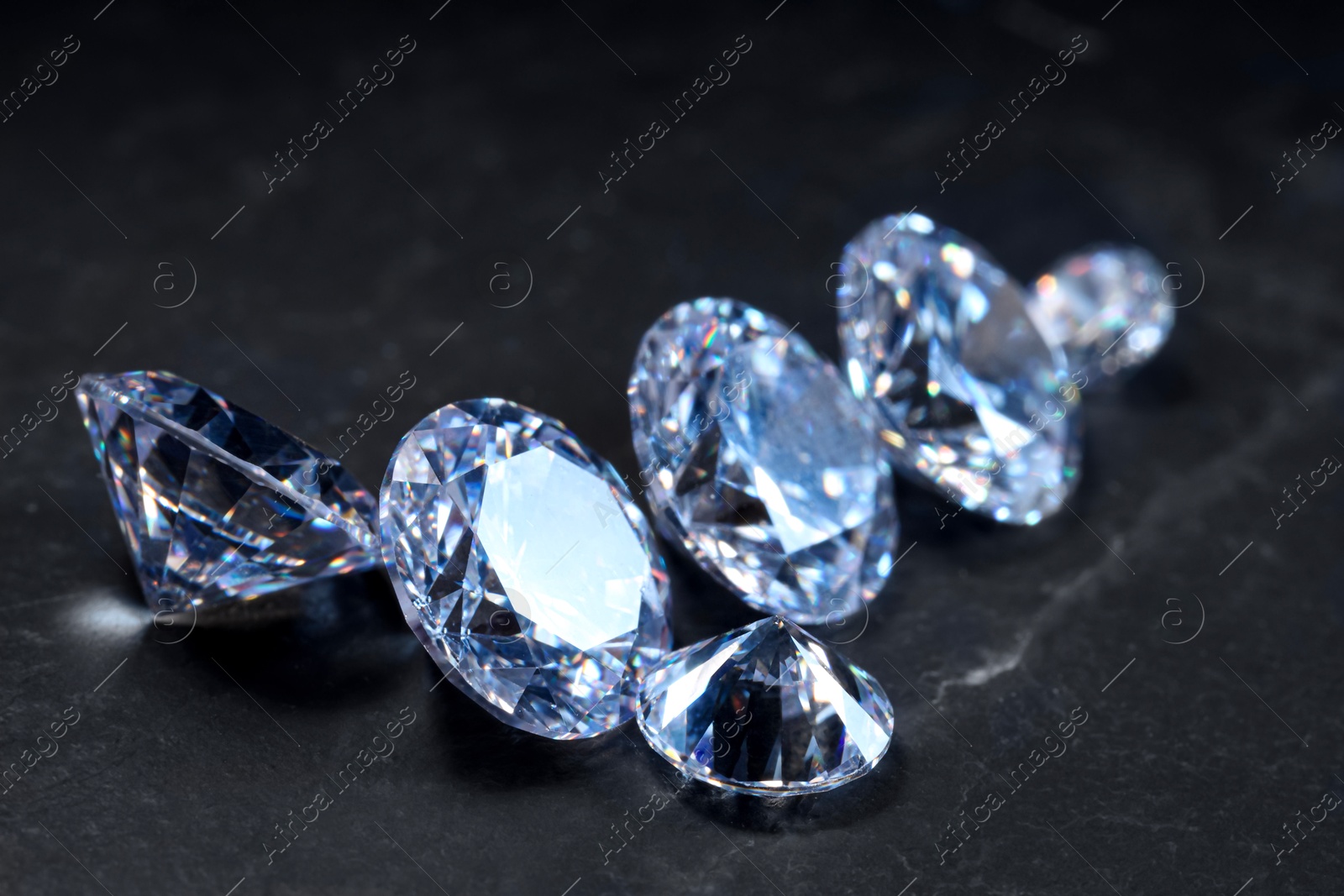 Photo of Beautiful shiny gemstones on black background, closeup