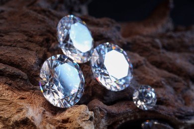 Photo of Beautiful shiny gemstones on stone, closeup view