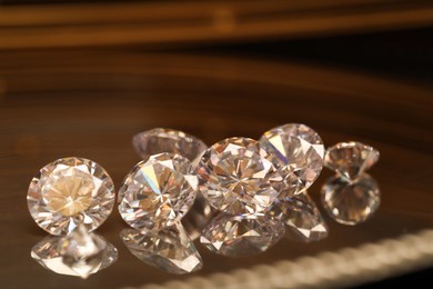 Photo of Beautiful shiny gemstones on golden tray, closeup