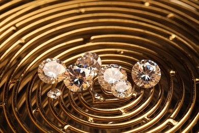 Photo of Beautiful shiny gemstones on golden tray, closeup