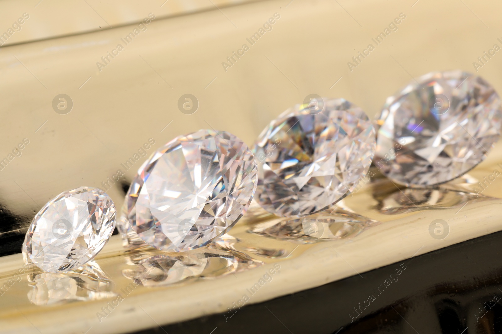 Photo of Beautiful shiny gemstones on light background, closeup