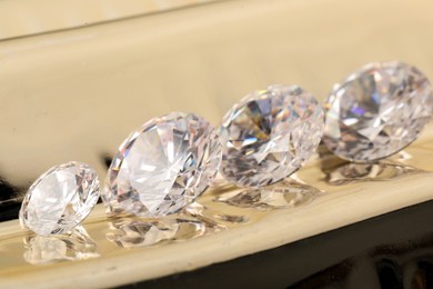 Photo of Beautiful shiny gemstones on light background, closeup