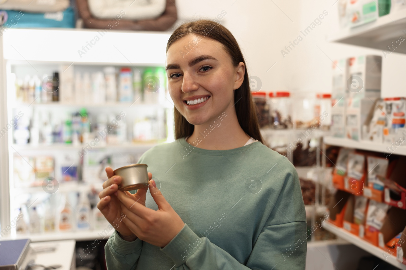 Photo of Woman with canned food in pet shop