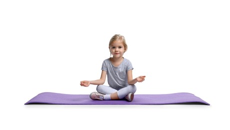 Photo of Little girl exercising on fitness mat against white background. Sport activity