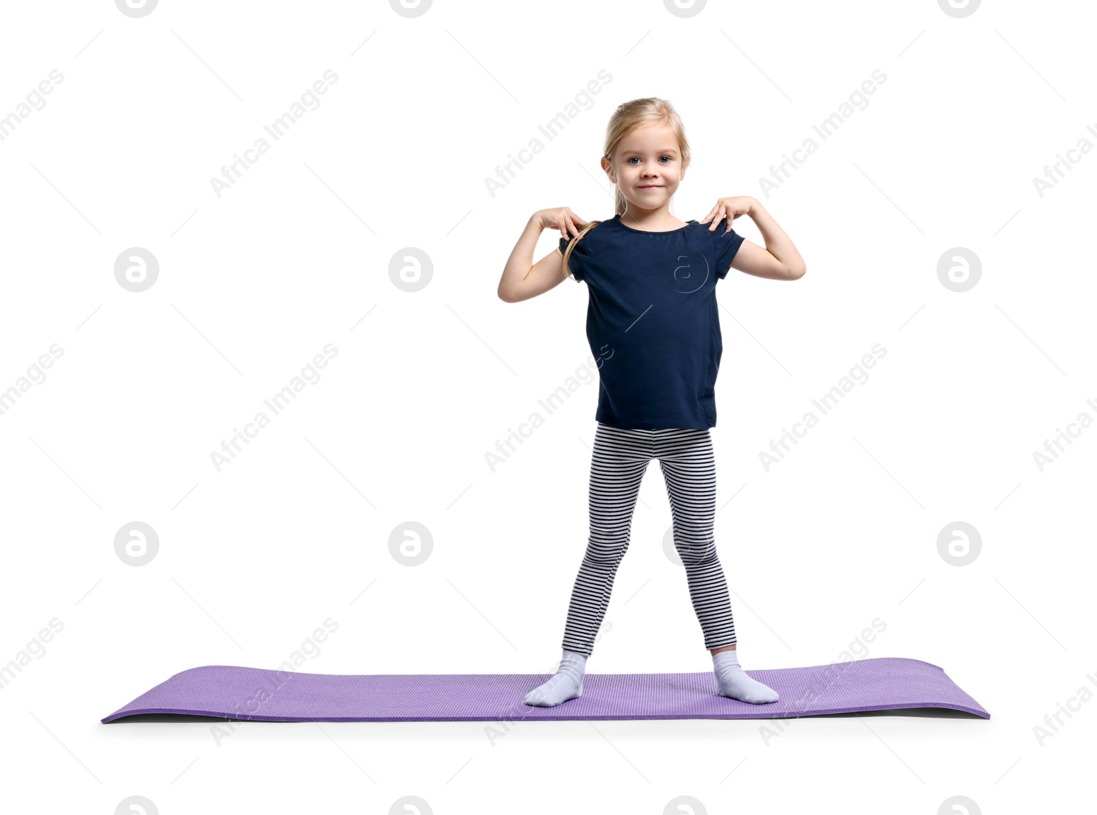 Photo of Little girl exercising on fitness mat against white background. Sport activity