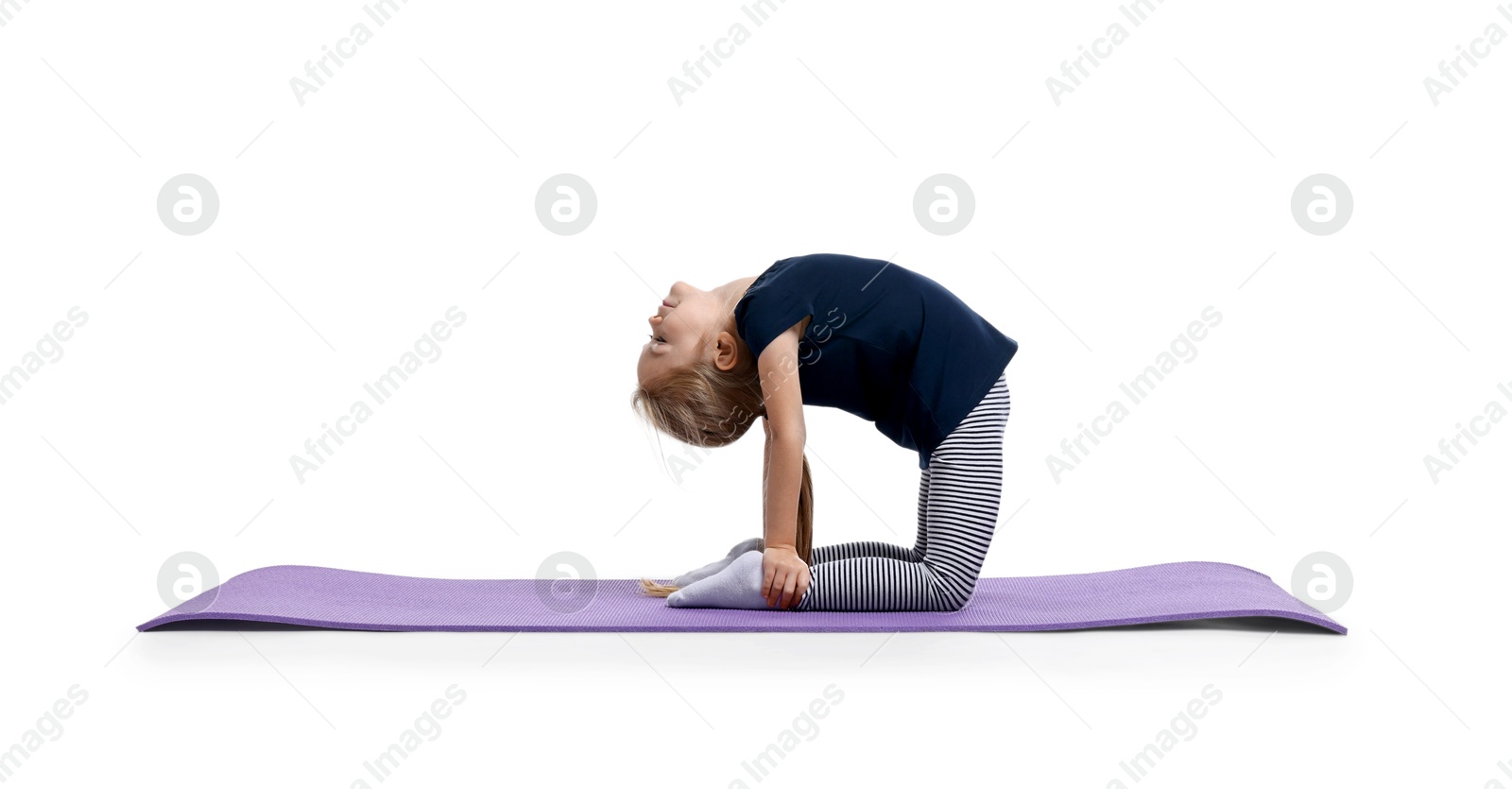 Photo of Little girl exercising on fitness mat against white background. Sport activity