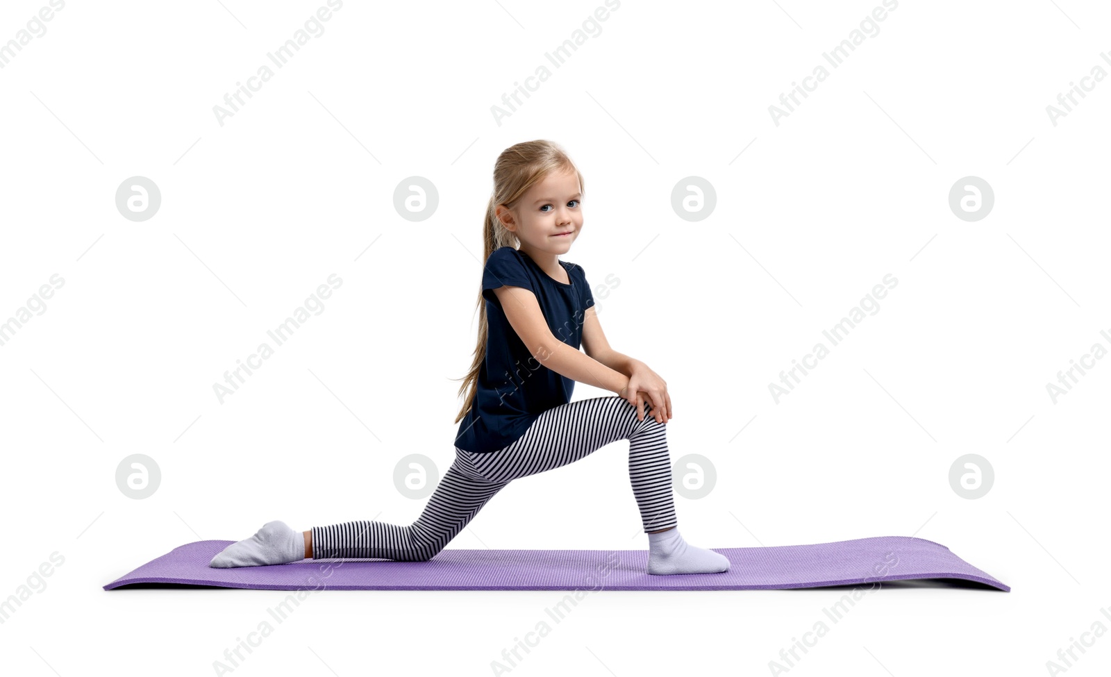 Photo of Little girl exercising on fitness mat against white background. Sport activity