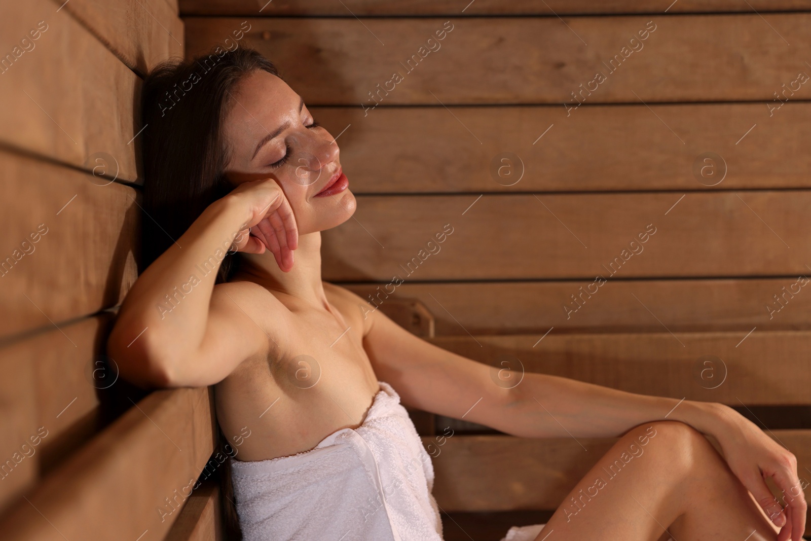 Photo of Beautiful woman relaxing at sauna. Space for text