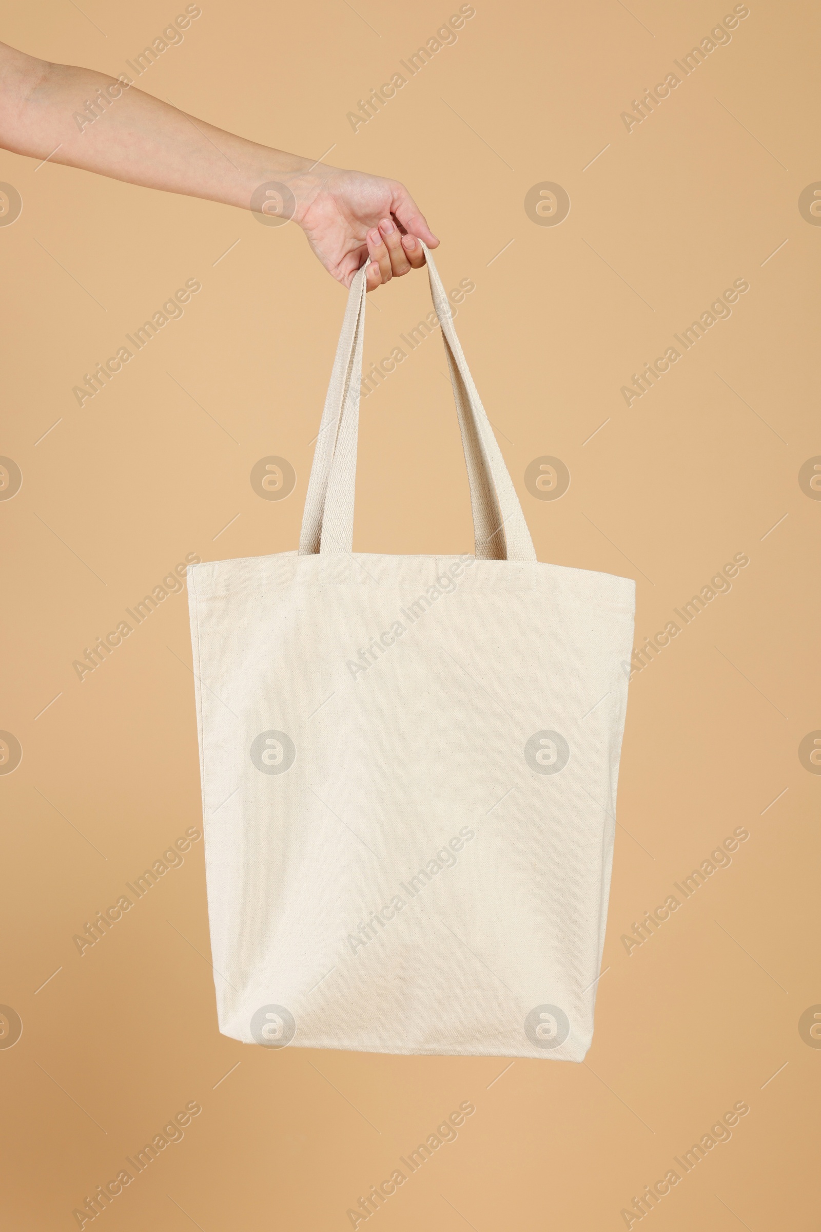 Photo of Woman with blank shopper bag on color background, closeup. Mockup for design