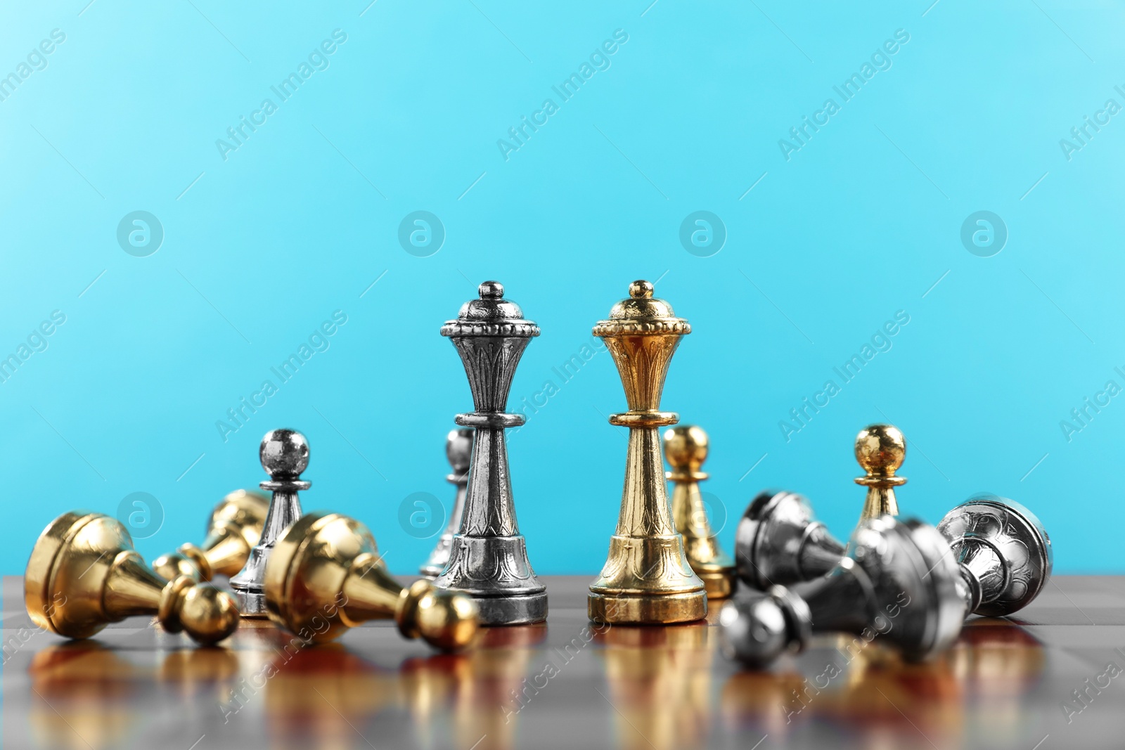 Photo of Chess queens and pawns on chessboard. Competition concept