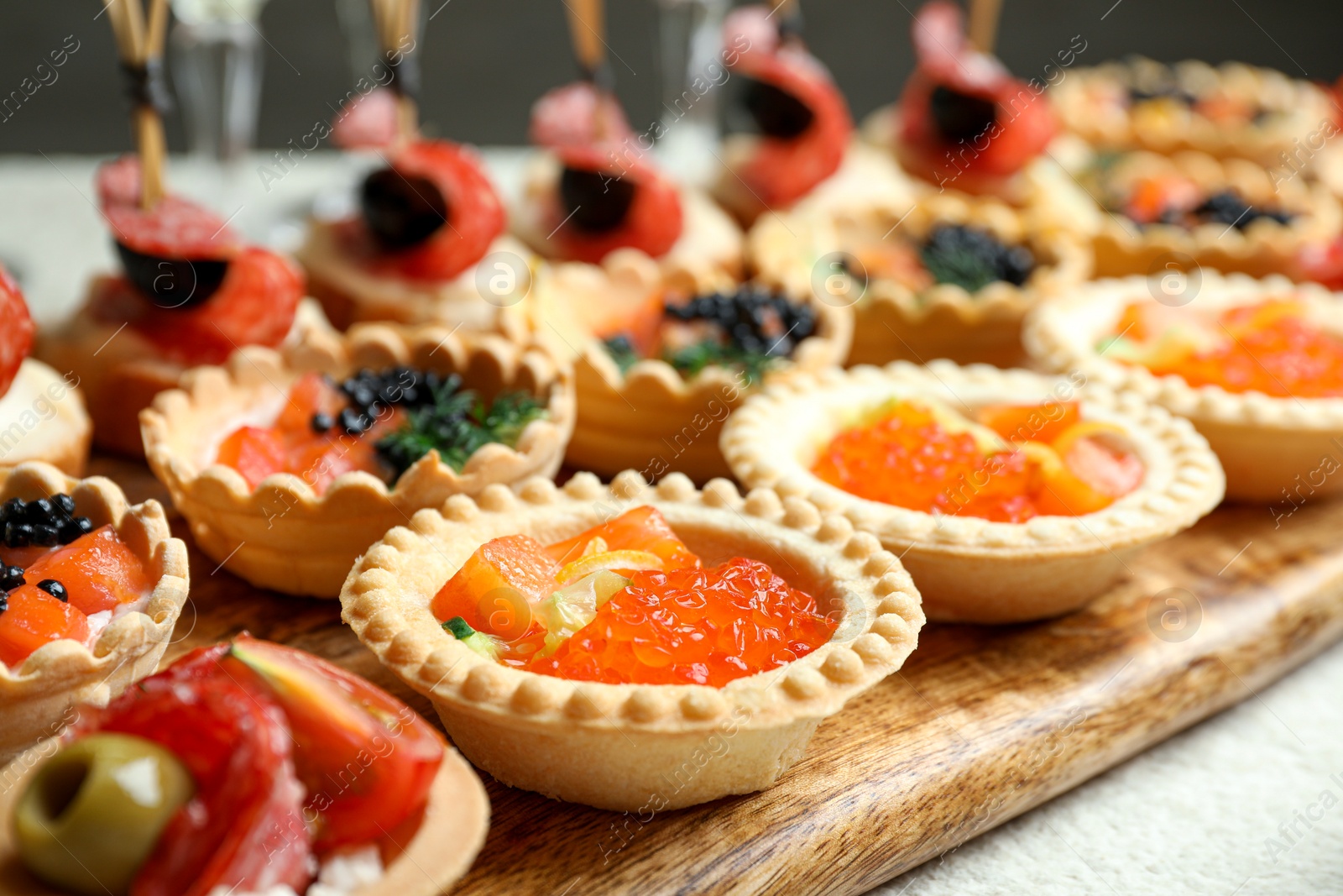 Photo of Many different tasty canapes on white table, closeup