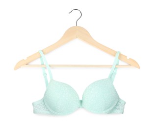 Photo of Beautiful turquoise bra on hanger against white background