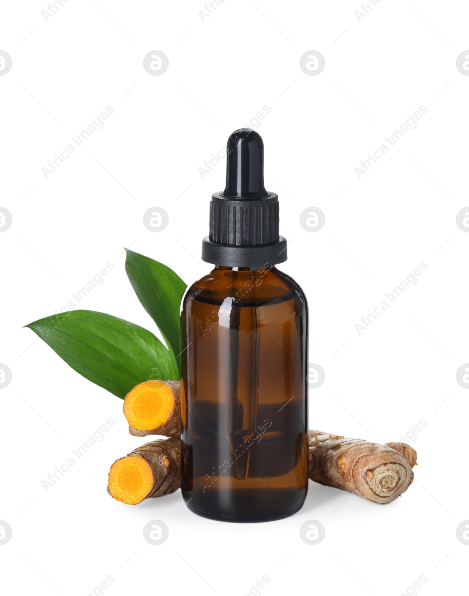 Photo of Bottle of turmeric essential oil, raw roots and leaves isolated on white