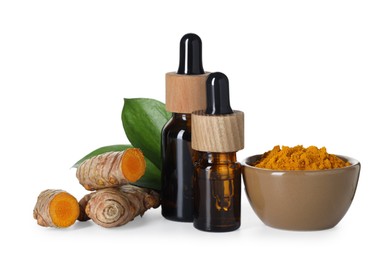 Photo of Bottles of turmeric essential oil, powder, raw roots and leaves isolated on white