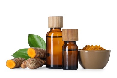 Photo of Bottles of turmeric essential oil, powder, raw roots and leaves isolated on white