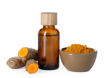 Photo of Bottle of turmeric essential oil, powder and raw roots isolated on white