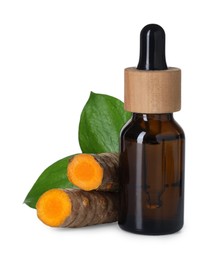 Photo of Bottle of turmeric essential oil, raw roots and leaves isolated on white