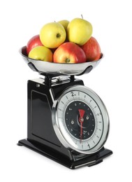 Photo of Retro mechanical kitchen scale with apples isolated on white