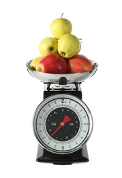 Photo of Retro mechanical kitchen scale with apples isolated on white