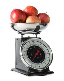 Photo of Retro mechanical kitchen scale with apples isolated on white