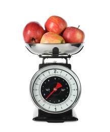 Photo of Retro mechanical kitchen scale with apples isolated on white