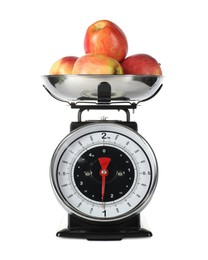 Photo of Retro mechanical kitchen scale with apples isolated on white