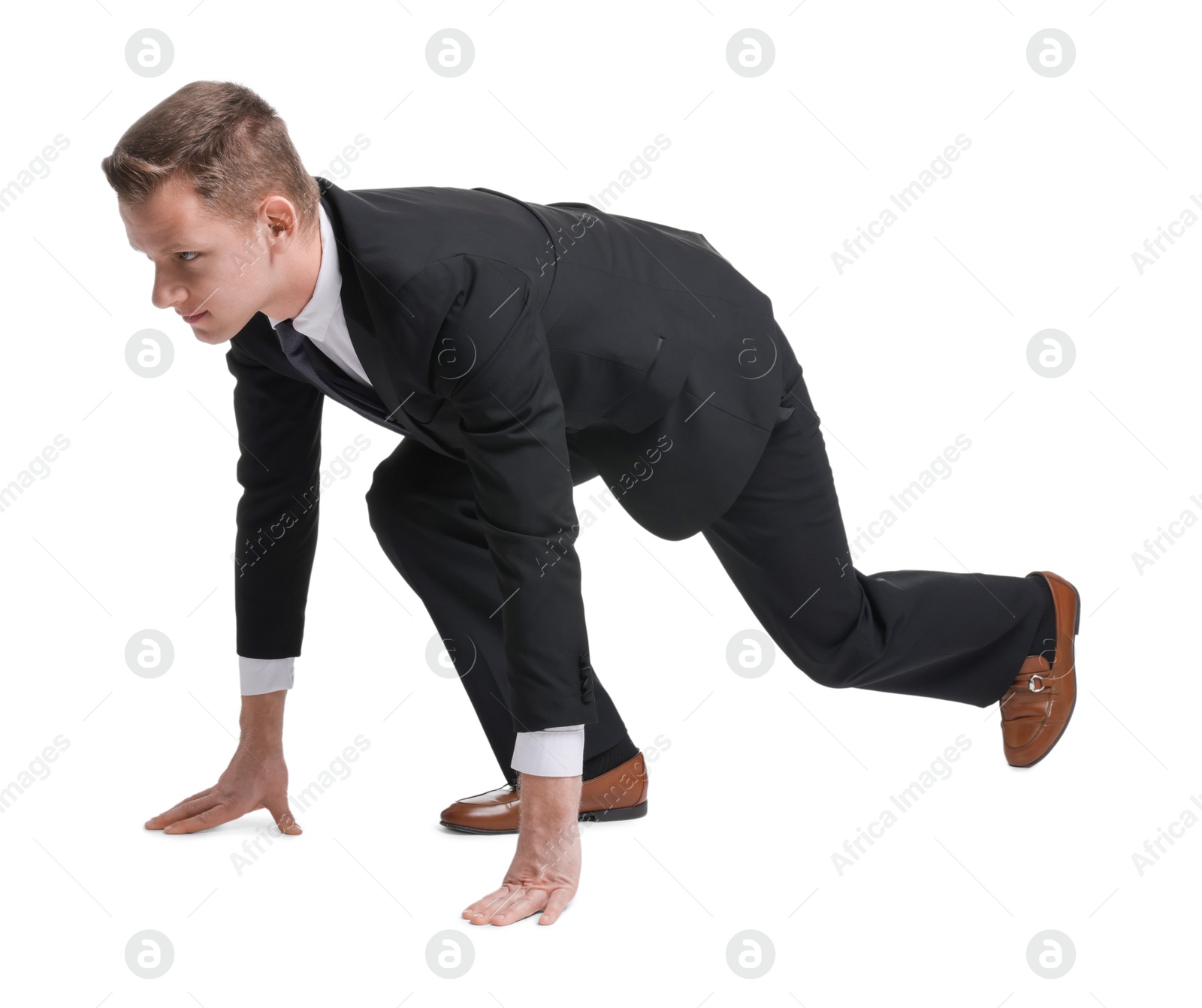 Photo of Businessman in starting position for run ready for competition on white background